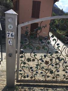 a gate with a wrought iron design on it at Apartments in Lezzeno Lake Como in Lezzeno