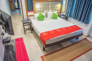 a bedroom with a large bed and a television at 36 Palms Residency - Sea View Villa in Cochin