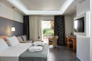a hotel room with two beds and a television at SENTIDO Apollo Palace in Mesongi
