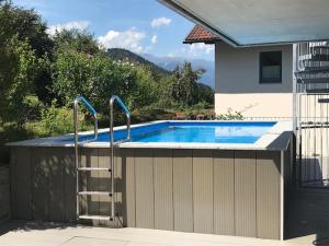 a swimming pool with a ladder next to a house at Exklusive Penthousewohnung mit Tesla-Wallbox in Innsbruck in Innsbruck