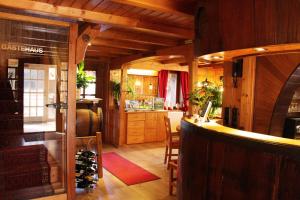 a tasting room with a bar and a kitchen at Pension WoGi in Wolfegg