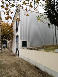 a white building on the side of a street at Apartment Junqueiro in Porto