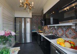 a kitchen with a refrigerator and fruits on the counter at Sara´s Bed and Breakfast in Erikslund