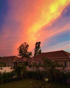 a rainbow in the sky above a house at Villa de Veluwe @ Hua Hin in Hua Hin