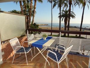 a table and chairs on a balcony with the beach at Penelope Apart in Sitges
