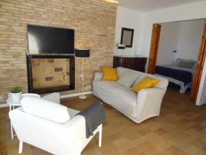 a living room with a couch and a fireplace at Penelope Apart in Sitges