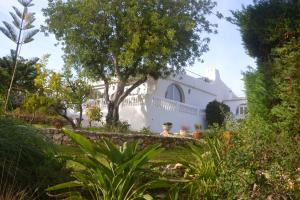 a white house with a white fence and trees at Villa on the Beach by GalanteVasques in Carvoeiro