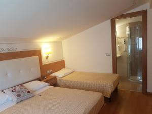 En eller flere senge i et værelse på Alphotel Milano