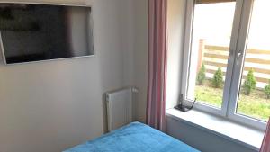 Telewizja i/lub zestaw kina domowego w obiekcie Lux Garden Apartment