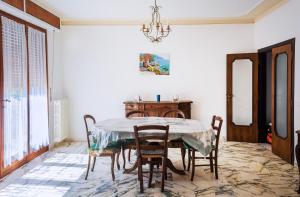 a dining room with a table and chairs at Tuscany By The Sea in Tirrenia