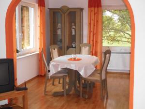 a dining room with a table and chairs at Ferienhaus Heideblick in Rüthen