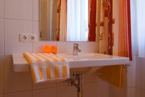 a bathroom with a sink and a mirror at Haus Bergheimat in Abtenau +96 photos