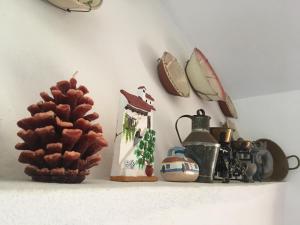 a shelf with a pine cone and other items on it at Monte da Linda, 5 mins from Melides beach in Melides