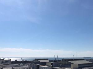 a view of a city with the ocean in the background at Office-Studio Theoxaris in Thessaloniki