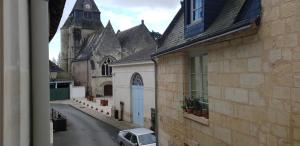 een auto geparkeerd op een straat voor een kerk bij NATURE & CHATEAUX in Azay-le-Rideau