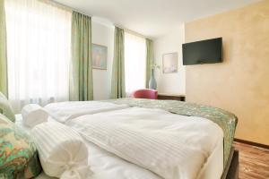 Postel nebo postele na pokoji v ubytování Hotel Tiffany