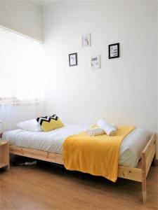 a bed with a wooden frame in a bedroom at D Wan Guest House in Peniche +32 photos