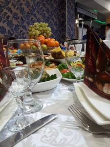 a table with wine glasses and plates of food at Гостиница ШАНЫРАК in Qyzylorda