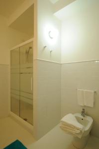 a bathroom with a shower and a toilet and a light at Baiadelconero in Numana