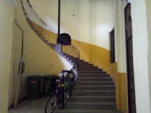 a bike parked next to a staircase in a building at Operahouse Rooms in Budapest