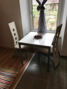 a dining room table with two chairs and a window at Arbeiterwohnungen Graz Hauptbahnhof in Graz