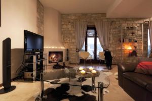 a living room with a couch and a fireplace at Parathalasso Villas in Monastiraki