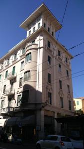 a tall white building with a car parked in front of it at Carlo's B149C - Sanremo Center Suite - da Carlo - in Sanremo