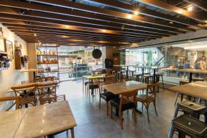 a restaurant with wooden tables and chairs in a room at Solace Hotel in Manila