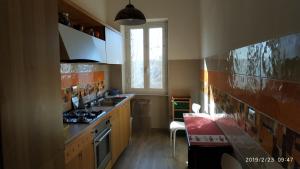 a kitchen with a sink and a stove top oven at GARBATELLA'S in ROME in Rome