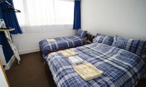 Postel nebo postele na pokoji v ubytování Lynmoore Guest House