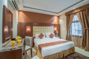 a hotel room with a bed and a desk and a window at Al Muhaidb Jarir - Al Malaz in Riyadh +27 photos