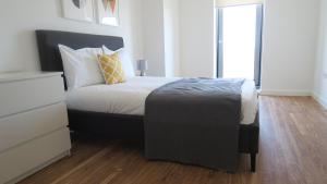 
a bed in a room with a white bedspread at Quay Apartments in Manchester
