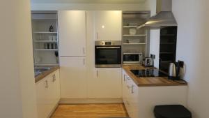 
a kitchen with a stove, sink and microwave at Quay Apartments in Manchester
