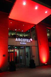 an office building with a red sign on the side of it at ARCOTEL Rubin - im Szeneviertel St Georg in Hamburg