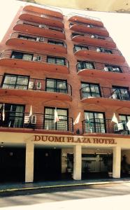 un gran edificio de ladrillo rojo con un hotel Dowment Plaza en Duomi Hotel Buenos Aires en Buenos Aires