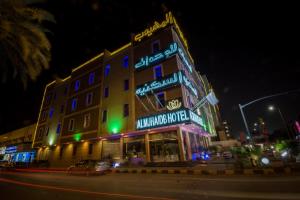 a building with neon signs on the side of a street at Al Muhaidb Jarir - Al Malaz in Riyadh