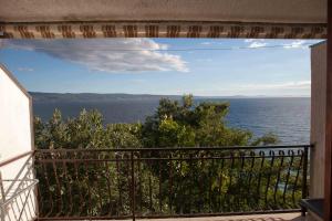 a view of the ocean from a balcony at Apartments Garac in Dugi Rat