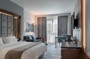 a hotel room with a bed and a living room at The Amman Landmark Hotel in Amman +81 photos