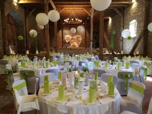 a room with white tables and chairs and lights at Landhotel Berggaststätte Bickenriede in Anrode