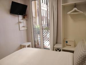 Postel nebo postele na pokoji v ubytování Pensión Easo