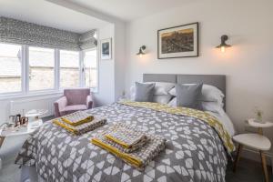 a bedroom with a bed with a gray and yellow comforter at Penwyth House in Newquay