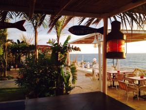 a restaurant with a table and chairs and the ocean at Le Blanc Bleu in Jbeil
