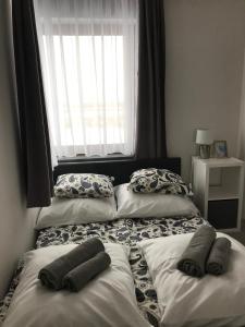 two beds in a bedroom with two pillows on them at Apartament koloru morza - Turkus in Łeba