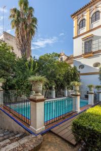 una piscina frente a un edificio en Villa Elvira, exclusive Pool and Gardens in the heart of Sevilla, en Sevilla