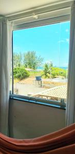 a window with a view of the ocean from a train at Ap aluguel no Guaibim in Guaibim