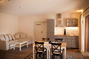 a living room with a couch and a table and chairs at Gästehaus Kerber in Merzig