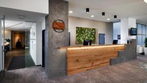 an office lobby with a reception desk and a mirror at OREA Resort Santon Brno in Brno