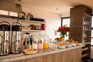 a kitchen counter with a bunch of food and drinks at Auka Boutique San Blas in Cusco