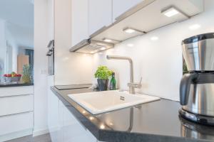 a kitchen with a sink and a counter top at Haus Strandperle in Börgerende-Rethwisch +101 photos