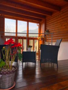 a porch with chairs and a table with flowers at Suites & Spa Galilee in Qiryat Shemona